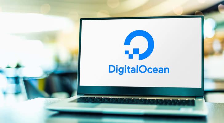 A laptop screen displays the logo for DigitalOcean (DOCN).