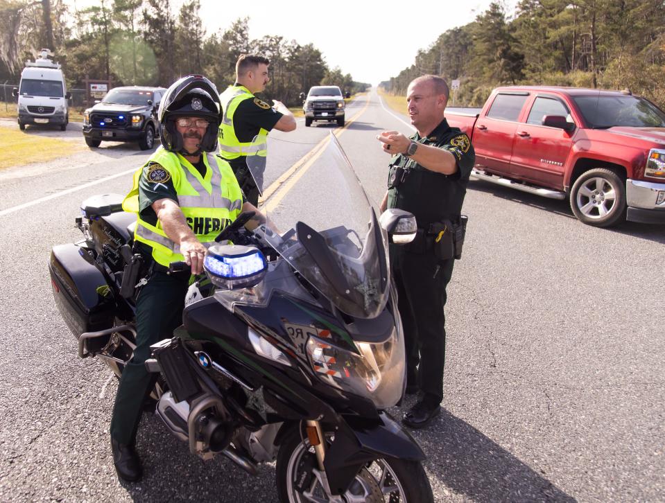 Marion County Sheriff’s Deputy Kevin Turner, left, Michael Stringer, center and Sgt. Paul Yeoumans, right, directs traffic near FR 88 on East SR40. The Marion County Sheriff's Office was involved in a high speed chase down East SR 40 Thursday afternoon, February 1, 2024 involving a stolen MCSO SUV. The fatal crash occurred past Forest Road 88 (FR11) west of the Juniper Springs entrance according to MCSO officials. [Doug Engle/Ocala Star Banner]2024