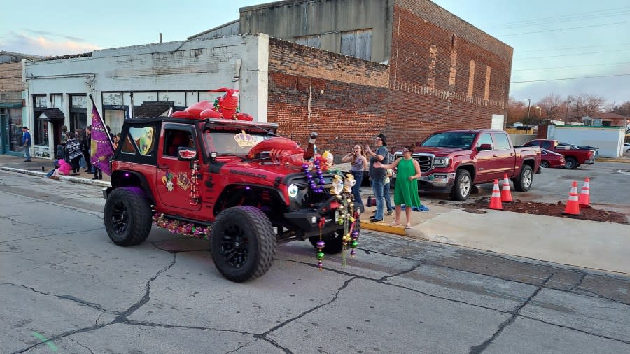 A Jeep decorated for Mardi Gras with several crawfish