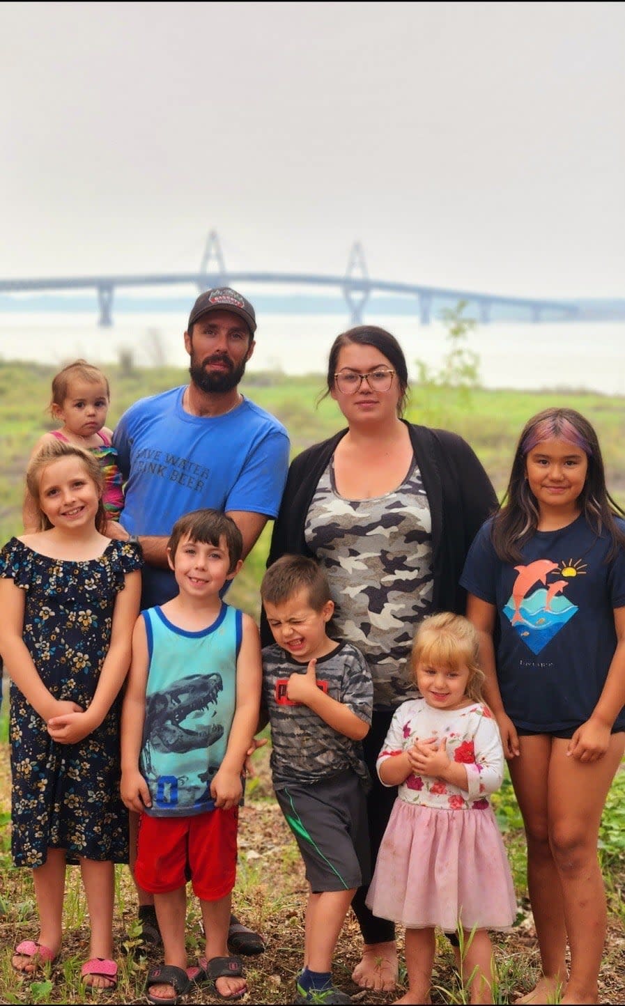 Natasha Cleary stands with her husband, John Cleary, their five children, and her step daughter. 