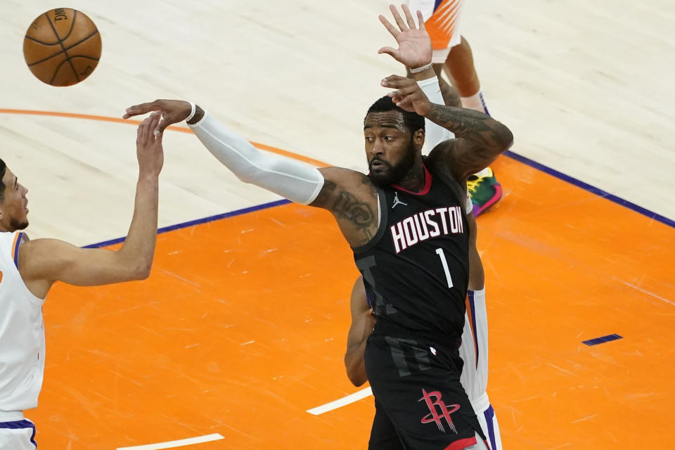 Houston Rockets guard Armoni Brooks (1) passes against the Phoenix Suns during the second half of an NBA basketball game, Monday, April 12, 2021, in Phoenix. (AP Photo/Matt York)