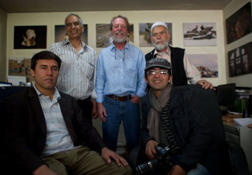 Agence France-Presse (AFP) photographer Massoud Hossaini (R) poses with colleagues including Shah Marai (L) and Lawrence Bartlett (C) at the AFP office in Kabul. Hossaini won the Pulitzer award for breaking news photography "for his heartbreaking image of a girl crying in fear after a suicide bomber's attack at a crowded shrine in Kabul," the committee announced