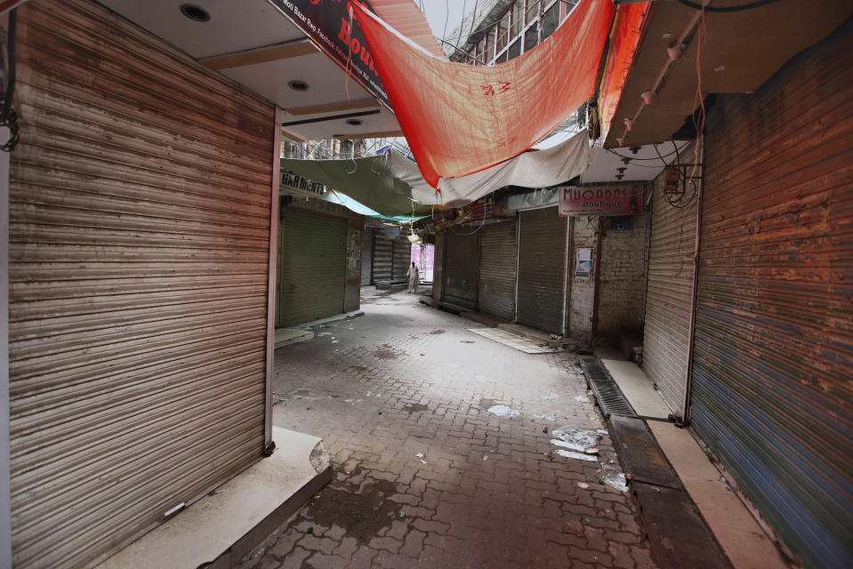 A Pakistani man walks through a main market which is closed due to a strike in Rawalpindi, Pakistan, Saturday, July 13, 2019. Pakistani traders have largely kept their business shut across the country against the new sales tax regime in the first budget of the new government they and opposition parties said came on the diktat of International Monetary Fund in turn of a $6bn bailout package. (AP Photo/Anjum Naveed)