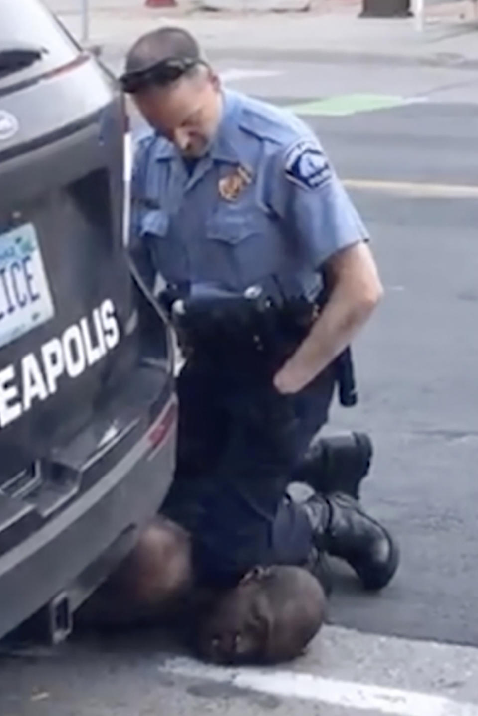 A police officer kneels on the neck of a handcuffed man who was pleading that he could not breathe in Minneapolis.