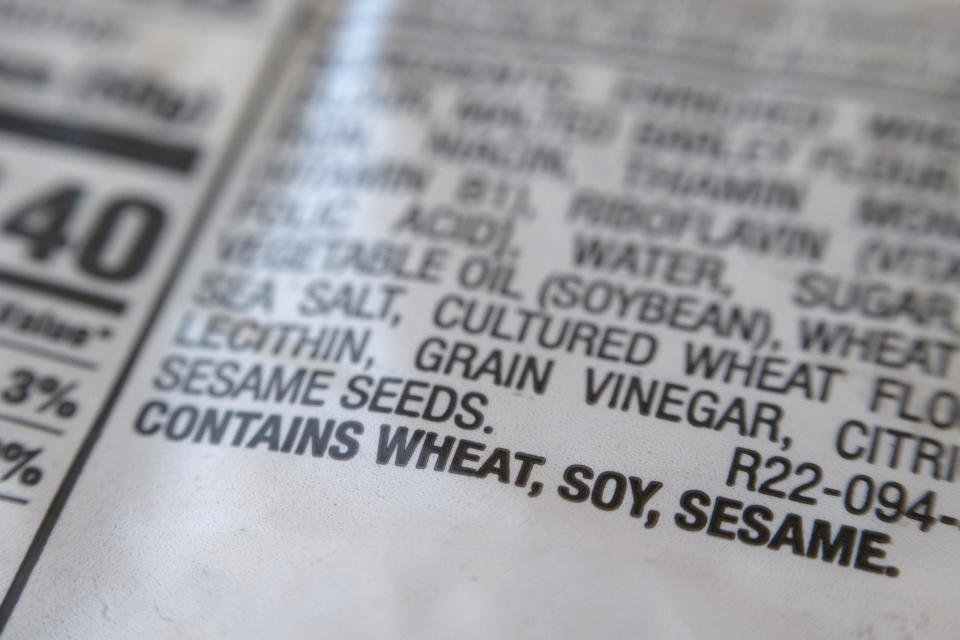 A notification for sesame is printed under the ingredient list on a bag of hot dog buns in New York on Wednesday, Dec. 21, 2022. A new federal law requiring that sesame be listed as an allergen on food labels is having unintended consequences _ increasing the number of products that include the ingredient. Starting Jan. 1, all foods made and sold in the U.S. must be labeled if they contain sesame, an often-hidden ingredient that's been declared the nation's ninth major allergen. (AP Photo/Patrick Sison)