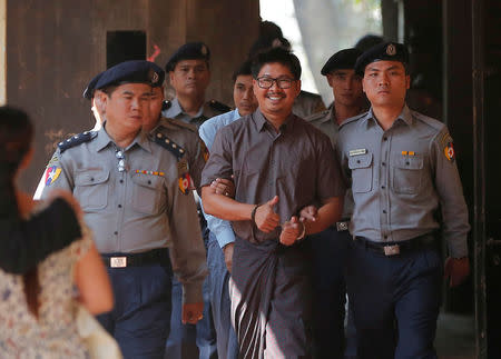 Detained Reuters journalists Wa Lone and Kyaw Soe Oo are escorted by police while arriving for a court hearing in Yangon, Myanmar March 7, 2018. REUTERS/Stringer