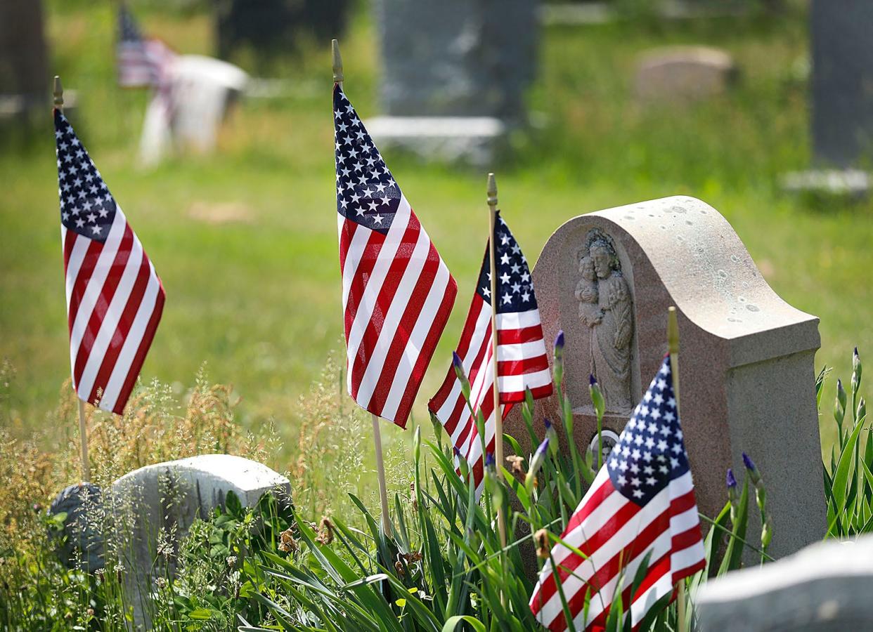 American flags adorn the graves of veterans.