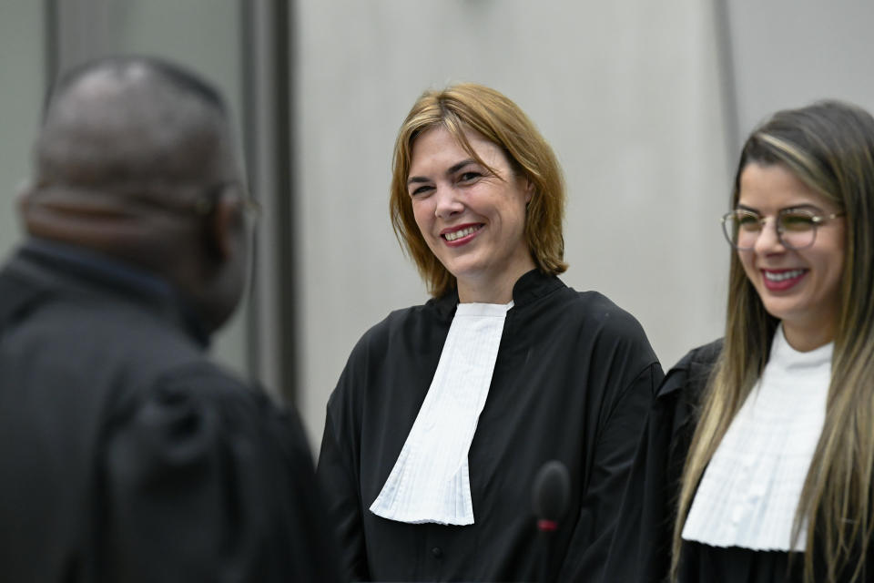 Defence lawyer Melinda Taylor, center, attends the trial of Al Hassan Ag Abdoul Aziz Ag Mohamed Ag Mahmoud, a Malian rebel accused of policing a brutal Islamic regime in the Malian city of Timbukti after rebels overran the historic desert city in 2012, at the International Criminal Court in The Hague, Netherlands, Monday May 9, 2022. (Piroschka van de Wouw/Pool via AP)