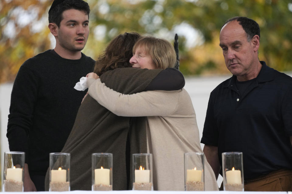 Relatives of Melvin Wax, one of 11 worshippers killed five years ago when a gunman opened fire at the Tree of Life synagogue in the Squirrel Hill neighborhood of Pittsburgh, hug after lighting a candle in his memory during a Commemoration Ceremony in Pittsburgh, on Friday, Oct. 27, 2023. (AP Photo/Gene J. Puskar)