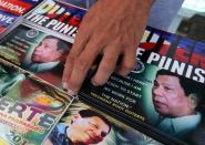 A vendor sells souvenir items with images of Philippine President Rodrigo Duterte in Davao city in southern Philippines, August 5, 2017. REUTERS/Lean Daval Jr/Files