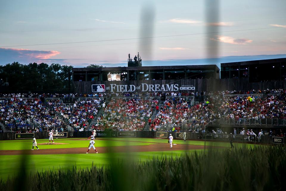 The sun sets during Thursday's Major League Baseball game between the Cincinnati Reds and Chicago Cubs at the Field of Dreams in Dyersville.