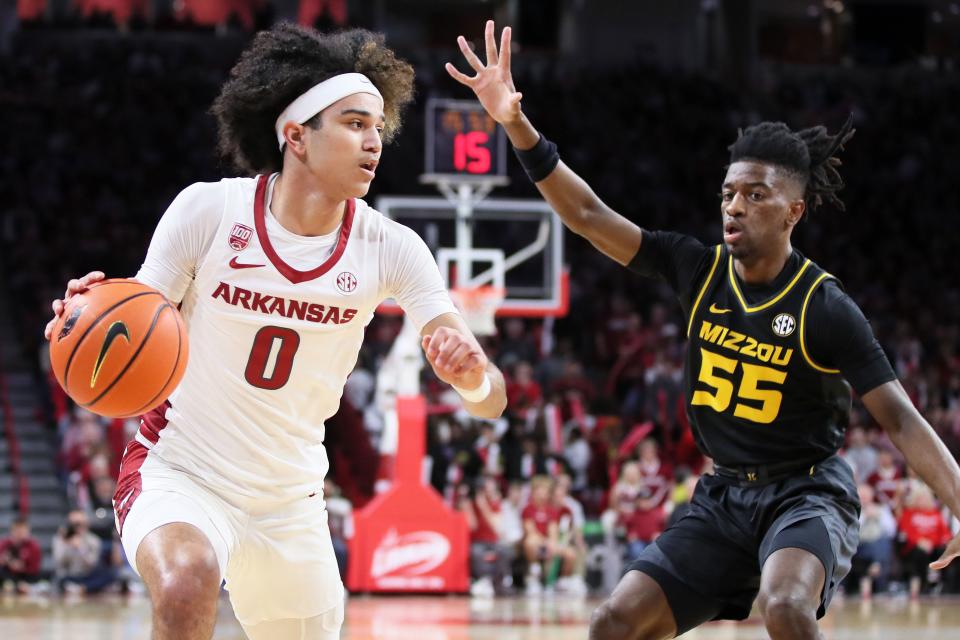 Razorbacks guard Anthony Black (0) drives in the first half as Missouri Tigers guard Sean East II (55) defends at Bud Walton Arena.