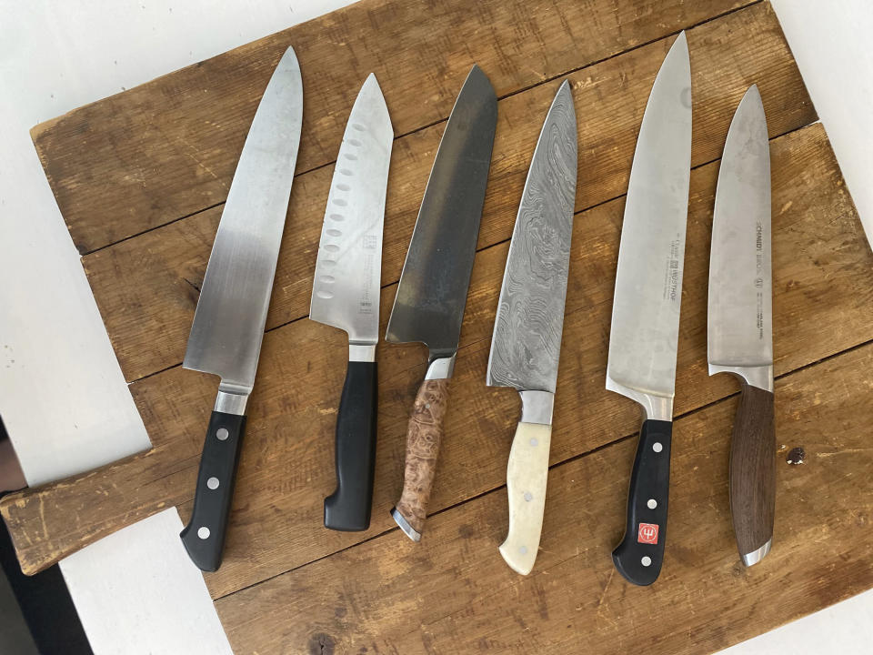 This July 2022 image shows a variety of kitchen knives. Many professionals will say you can perform virtually any kitchen task skillfully with either a chef’s knife or a paring knife. Adding other knives to your arsenal is appealing and can be useful but isn't strictly necessary. (Katie Workman via AP)