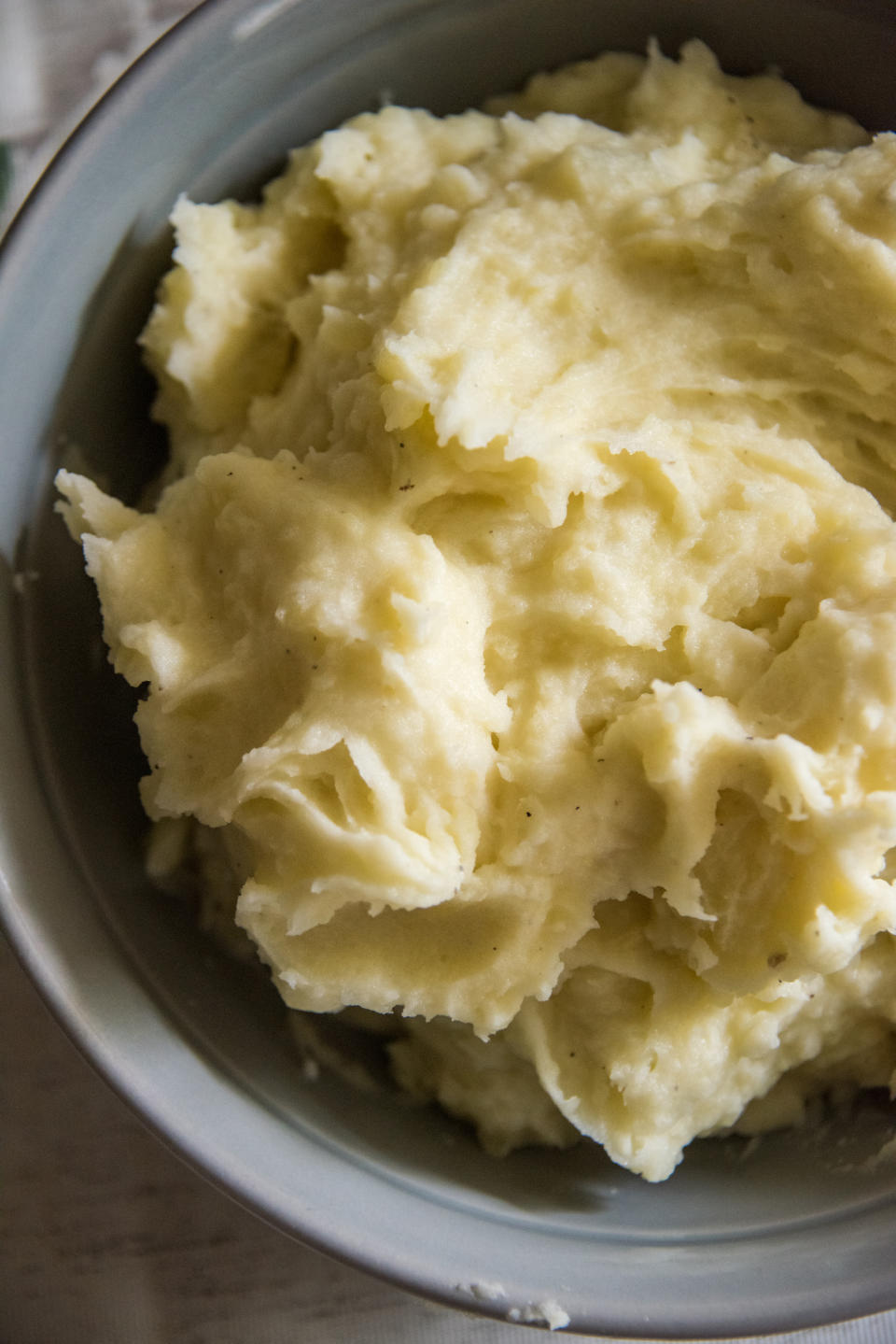 A bowl of creamy mashed potatoes with a smooth texture, served in a bowl