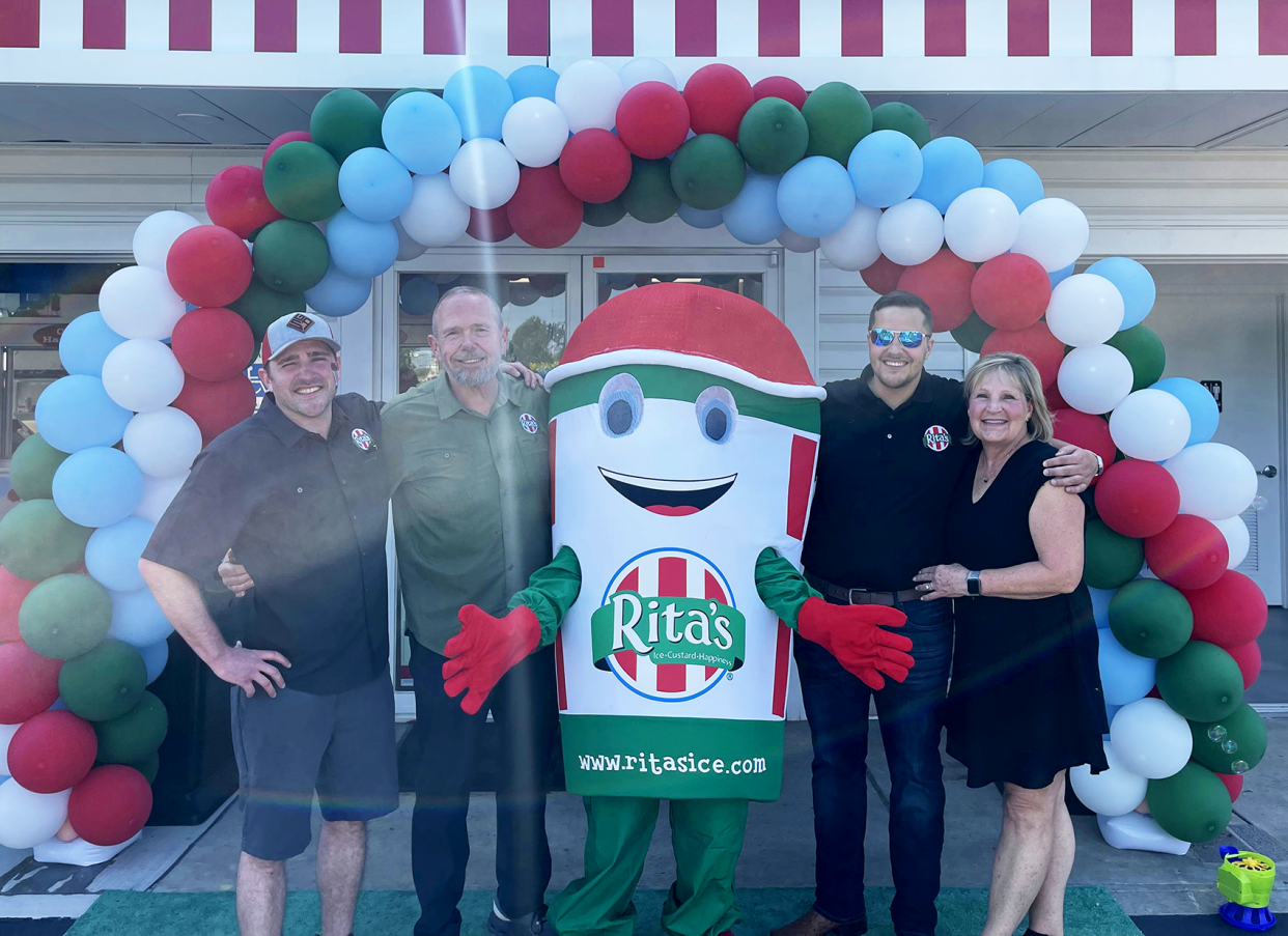 The Myers family celebrates the grand opening of Rita’s Italian Ice & Frozen Custard in Streetsboro. Husband and wife Jim and Karen Myers own the shop and their sons, Danny and Jay, help run the business. From left are Danny Myers, Jim Myers, Jay Myers, Karen Myers.