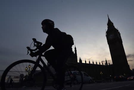 A cyclist rides past the Houses of Parliament at dusk in London, Britain, January 18, 2016. REUTERS/Toby Melville