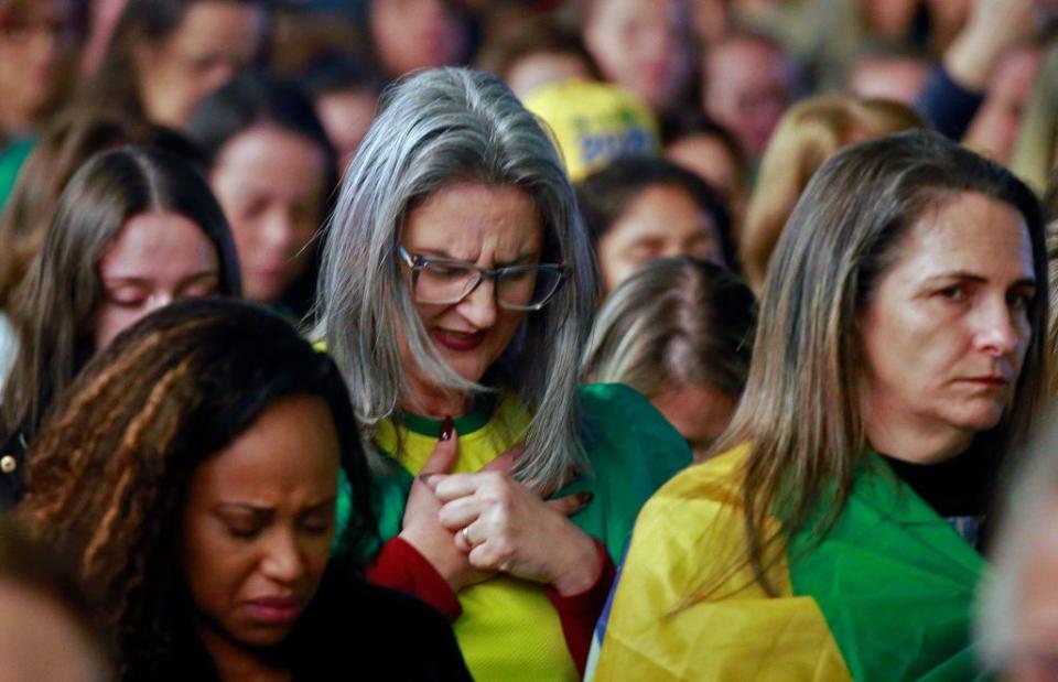 Women pray during the 'Women for Life and Family' event organized by the Liberal Party-Women in support of Bolsonaro, in Novo Hamburgo, Rio Grande do Sul State, Brazil, on Sept. 3, 2022.<span class="copyright">SILVIO AVILA/AFP via Getty Images</span>