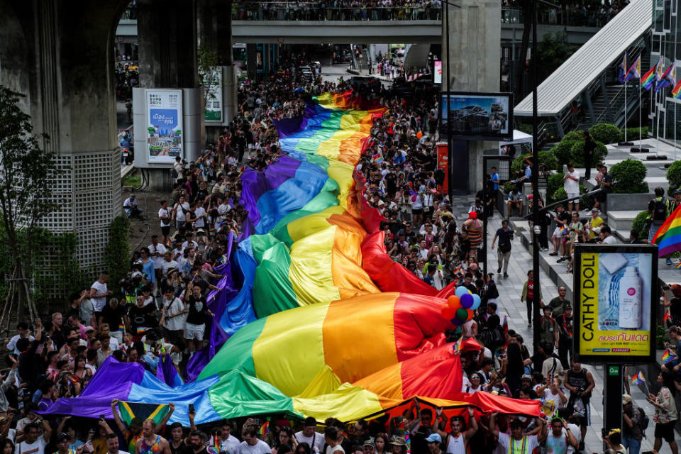 People carry a large rainbow-colored flag as they take part in the LGBTQ+ parade to mark the Pride Month celebrations in Bangkok, Thailand, on June 1, 2024. <span class="copyright">Anusak Laowilas—Getty Images</span>