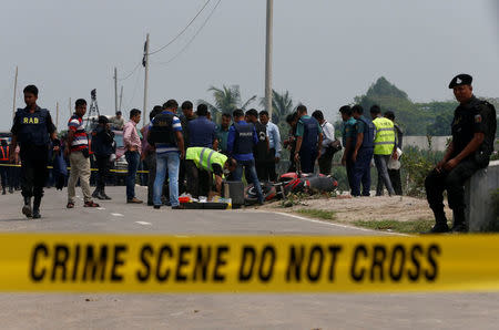 Crime Scene Unit works on the spot where police shot dead a suspected militant who tried to enter a security checkpost on a motorcycle armed with explosives in Khilgaon, outskirt of Dhaka, Bangladesh, March 18, 2017. REUTERS/Mohammad Ponir Hossain