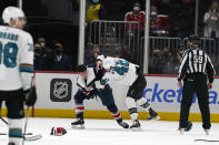 San Jose Sharks left wing Jonah Gadjovich (42) and Washington Capitals right wing Garnet Hathaway (21) fight after an NHL hockey game, Wednesday, Jan. 26, 2022, in Washington. The Sharks defeated the Capitals 4-1. (AP Photo/Evan Vucci)