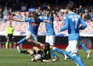 Football Soccer - Napoli v Verona - Italian Serie A - San Paolo Stadium, Napoli, Italy - 10/04/16. Verona's Juanito Gomez (bottom) in action against Napoli's Jorginho (L) and Vlad Chiriches (C). REUTERS/Ciro De Luca