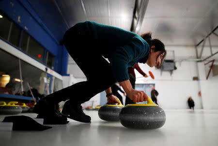 A Yazidi refugee from Kurdistan learns the sport of curling at the Royal Canadian Curling Club during an event put on by the "Together Project", in Toronto, March 15, 2017. REUTERS/Mark Blinch