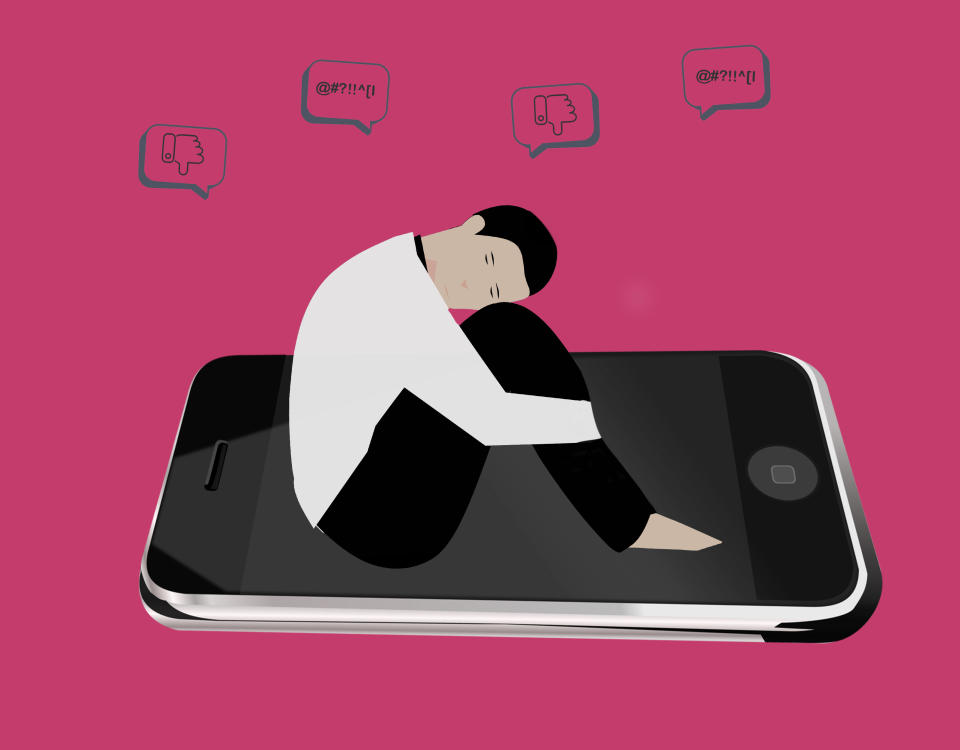 A graphic illustration of a sad person sitting on their phone because of social media. (Photo via Getty Images)