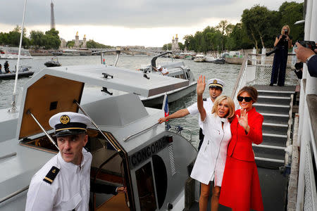 FILE PHOTO - Brigitte Macron, wife of French President Macron, and U.S. First Lady Melania Trump (R) wave after a boat tour July 13, 2017 on the Seine River in Paris, France. REUTERS/Philippe Wojazer/File Photo