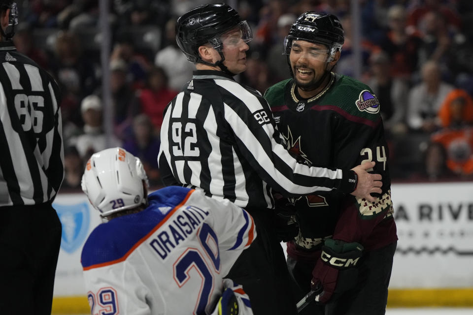 Arizona Coyotes defenseman Matt Dumba (24) has words with Edmonton Oilers center Leon Draisaiti in the first period during an NHL hockey game, Monday, Feb. 19, 2024, in Tempe, Ariz. (AP Photo/Rick Scuteri)