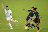 United States forward Alex Morgan (13) scores a goal between forward Christen Press (23) and Argentinal defender Aldana Cometti (6) during the second half of a SheBelieves Cup women's soccer match, Wednesday, Feb. 24, 2021, in Orlando, Fla. (AP Photo/Phelan M. Ebenhack)