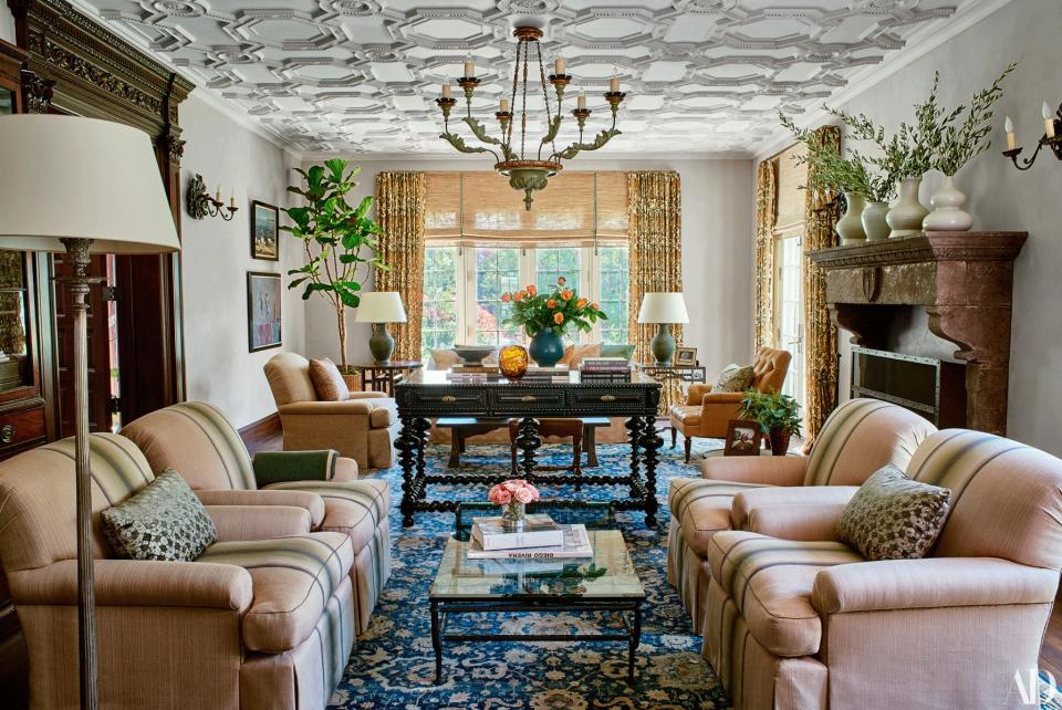 A Paul Ferrante chandelier hangs in the living room. Club chairs by Jasper in a custom fabric from Studio Four NYC; cocktail table from JF Chen.