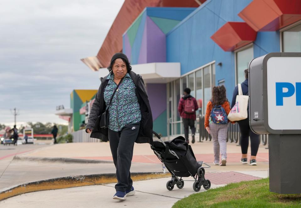 Irene Ray walks away with her groceries from the H-E-B on South Congress Avenue near Slaughter Lane to a nearby bus stop on Tuesday. Ray rides buses from her home in Del Valle to the H-E-B to get products that she said either are not available or are priced high at the convenience stores and mini-markets in her neighborhood.