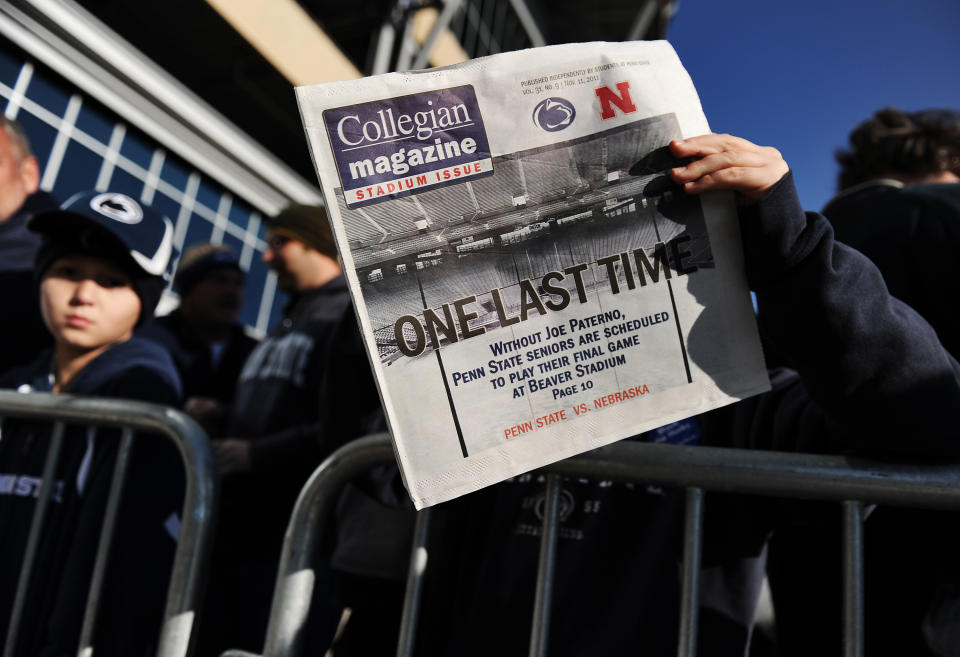STATE COLLEGE, PA - NOVEMBER 12: A child reads a newspaper that reads "One Last Time" before the Penn State against Nebraska football game at Beaver Stadium on November 12, 2011 in State College, Pennsylvania. Head football coach Joe Paterno was fired amid allegations that former Penn State defensive coordinator Jerry Sandusky was involved with child sex abuse. Penn State is playing their final home football game against Nebraska. (Photo by Patrick Smith/Getty Images)