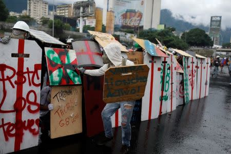 Demonstrators gather in front of an Air Force base during a rally against Venezuelan President Nicolas Maduro's government in Caracas, Venezuela, June 24, 2017. REUTERS/Marco Bello