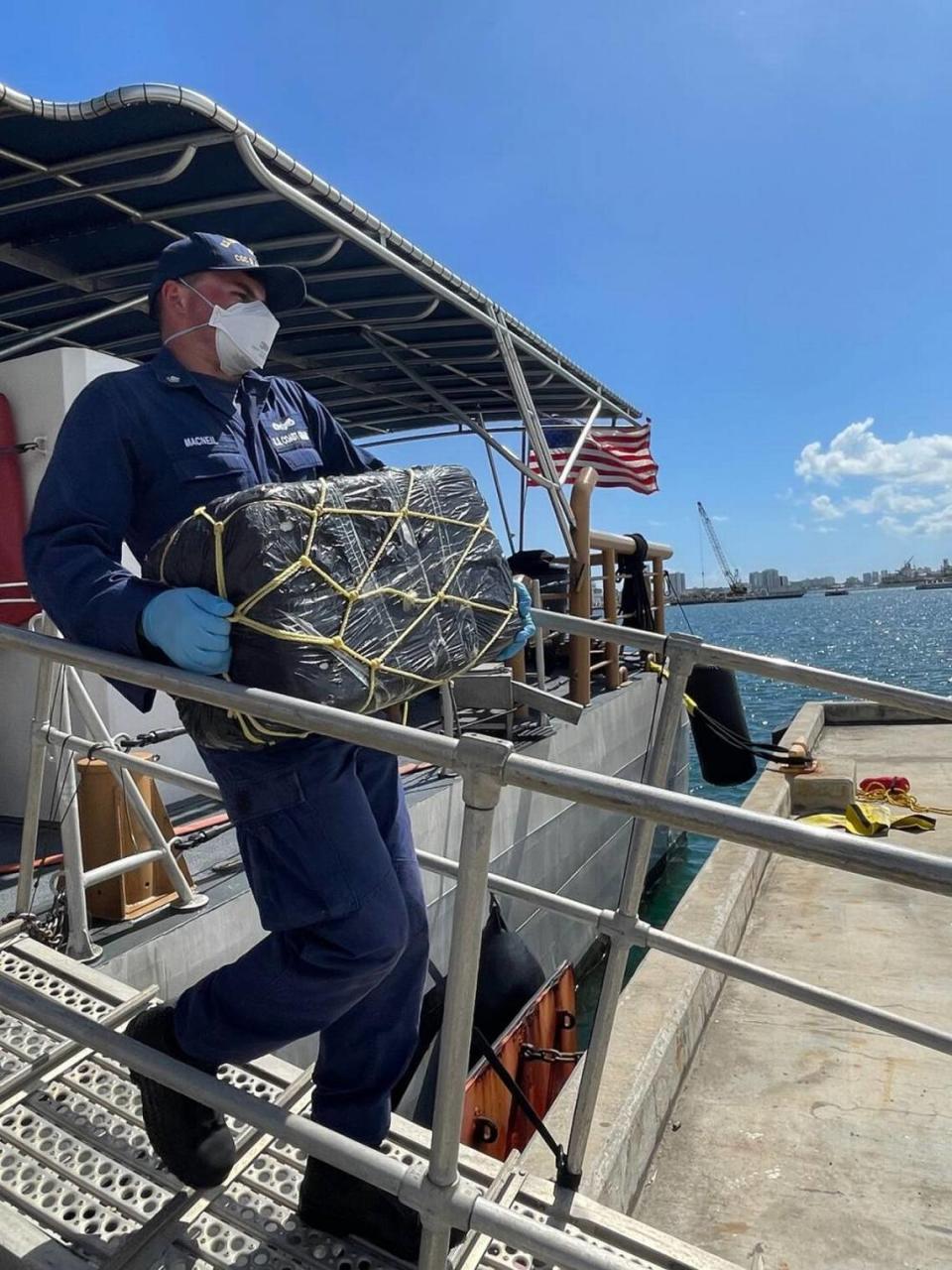 A Coast Guard Cutter Donald Horsley crew member helps offload about 1,000 kilograms of seized cocaine, valued at $20 million, at Coast Guard Base San Juan on April 4, 2022.