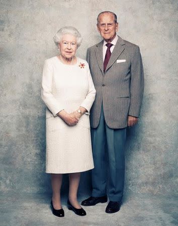 A handout photo shows Britain's Queen Elizabeth and Prince Philip in the White Drawing Room at Windsor Castle in early November, pictured against a platinum-textured backdrop, in celebration of their platinum wedding anniversary on November 20, 2017. Matt Holyoak/CameraPress/PA Wire/Handout via REUTERS