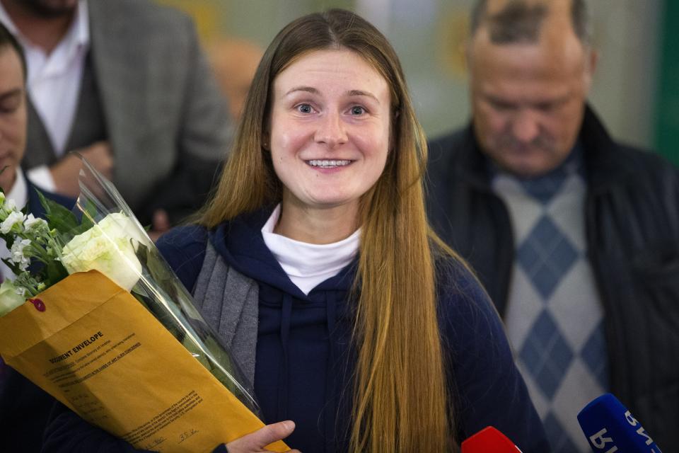 Russian agent Maria Butina smiles as she speaks to journalists upon her arrival from the United States at Moscow International Airport Sheremetyevo outside Moscow Moscow, Russia, Saturday, Oct. 26, 2019. Butina, a gun rights activist who sought to infiltrate conservative U.S. political groups and promote Russia's agenda around the time that Donald Trump rose to power, was released Friday from a low-security facility in Florida. (AP Photo/Alexander Zemlianichenko)