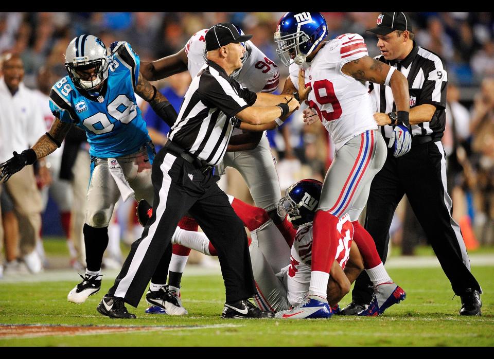 Officials separate Michael Boley #59 of the New York Giants and Steve Smith #89 of the Carolina Panthers as the scuffle after a play at Bank of America Stadium on September 20, 2012 in Charlotte, North Carolina.