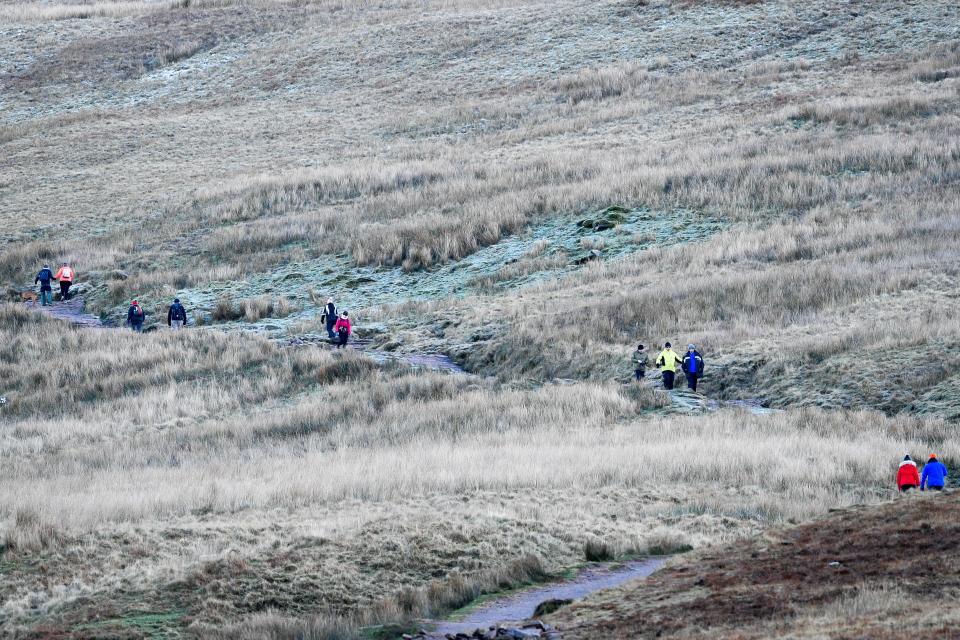 Walkers braving the cold on Pen y Fan mountain in the Brecon Beacons National Park yesterday (PA)