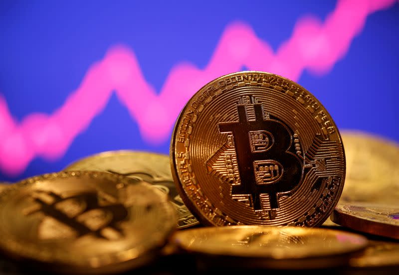 FILE PHOTO: A representation of virtual currency Bitcoin is seen in front of a stock graph in this illustration taken