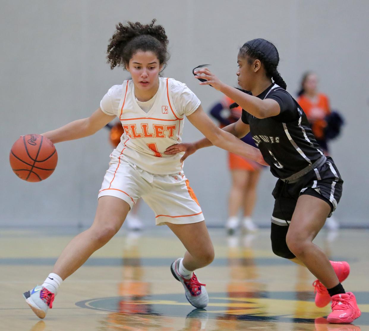 Ellet's Caitlyn Holmes, left, moves up the court against Buchtel's Aaliyah Golden during the first half of a high school basketball game, Wednesday, Jan. 31, 2024, in Akron, Ohio.