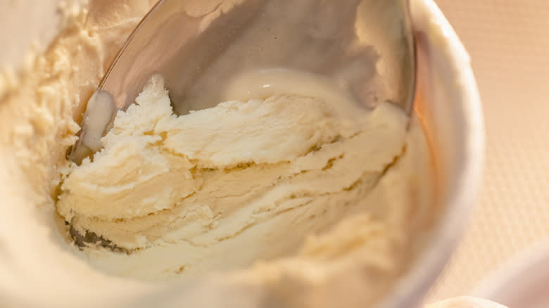 scooping soft vanilla ice cream