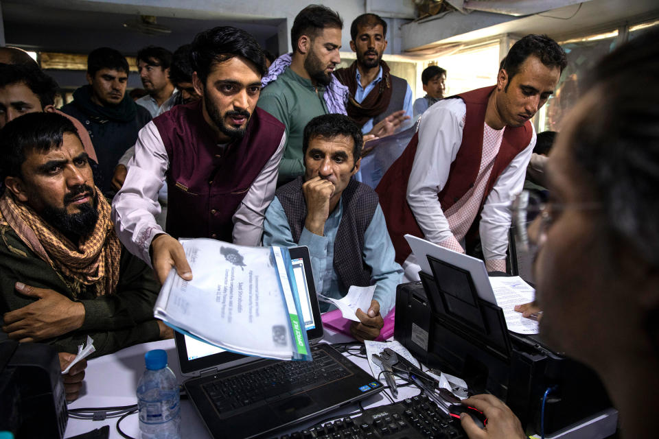 Men crowd into an Internet café while seeking help with applications for the Special Immigrant Visa program in Kabul on Aug. 8.<span class="copyright">Paula Bronstein—Getty Images</span>