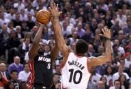 Miami Heat forward Luol Deng (9) takes a shot past the arm of Toronto Raptors guard DeMar DeRozan (10) in game two of the second round of the NBA Playoffs at Air Canada Centre. The Raptors won 96-92. Mandatory Credit: Dan Hamilton-USA TODAY Sports