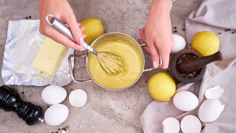 Person making hollandaise sauce