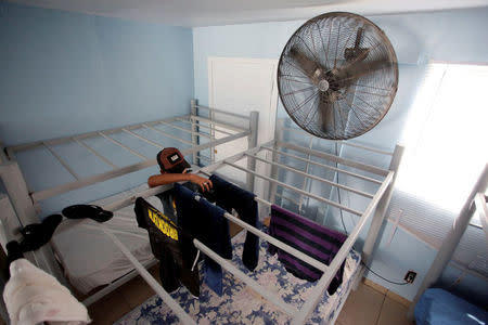 A Mexican migrant child arranges freshly-washed clothing at the Senda de Vida migrant shelter in Reynosa, in Tamaulipas state, Mexico June 22, 2018. Picture taken June 22, 2018. REUTERS/Daniel Becerril