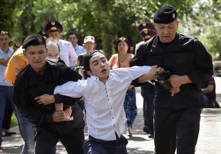 Police officers detain an opposition supporter attempting to stage a protest rally in Almaty, Kazakhstan June 23, 2018. REUTERS/Mariya Gordeyeva