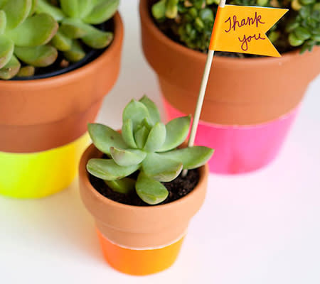 Photo by: Armelle Blog<br><br><b>Painted potted plants</b> <br> Another quick and fun DIY for your party. Plant flowers or succulents in these neon dipped (or hand painted) pots. Decorate your tables with them and then send them home as favors after the party (or keep them to decorate your home)! <br> <i><a rel="nofollow noopener" href="http://www.disneybaby.com/blog/trend-alert-10-inspiring-ideas-for-a-neon-baby-shower/#slide3" target="_blank" data-ylk="slk:Get the tutorial;elm:context_link;itc:0;sec:content-canvas" class="link "><b>Get the tutorial</b></a></i>