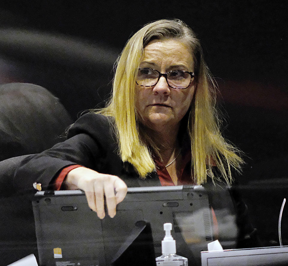 Sen. Amanda Chase, R-Chesterfield, packs up her computer as she prepares to leave during the floor session of the Virginia Senate inside the Science Museum in Richmond, Va., Tuesday, Jan. 26, 2021. She had asked that the censure resolution against her be put off for another day after announcing that her mother-in-law had open-heart surgery. The Senate members agreed to put the vote off for a day. (Bob Brown/Richmond Times-Dispatch via AP)