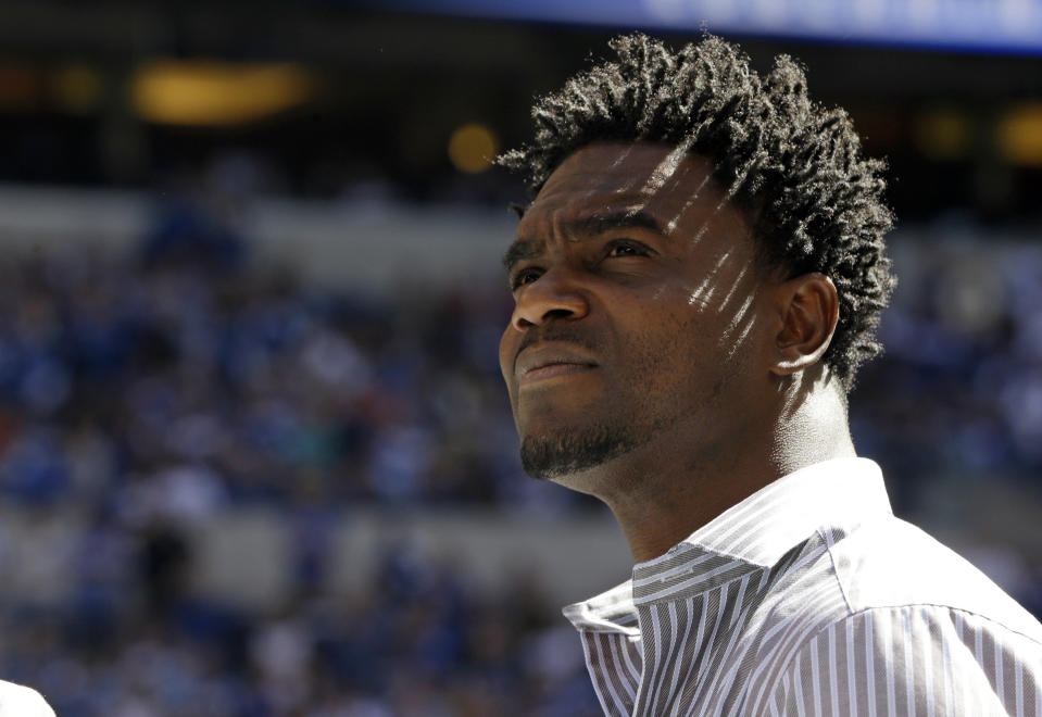 FILE - Former Indianapolis Colts running back Edgerrin James watches as his name was added to the team's Ring of Honor during an NFL football game between the Indianapolis Colts and the Jacksonville Jaguars in Indianapolis, in this Sunday, Sept. 23, 2012, file photo. The man drafted fourth overall in 1999 — ahead of Heisman Trophy winner Ricky Williams and as the hand-picked replacement for Marshall Faulk — carved out his own Hall of Fame career with a gritty work ethic, a freewheeling personality and a commitment to stay true to his roots.(AP Photo/Darron Cummings, File)